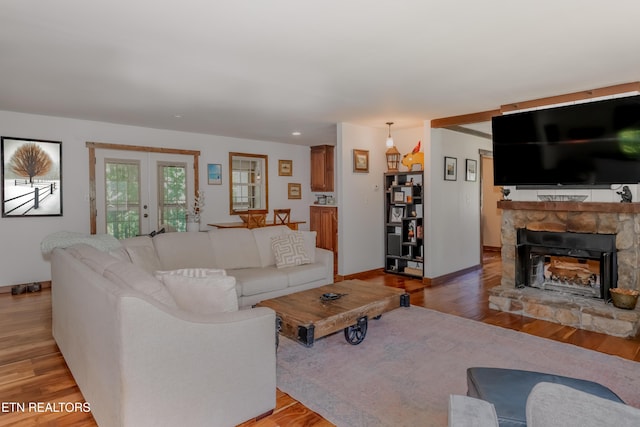 1932 Duncan Rd, Knoxville, TN 37919 - living room featuring light wood-type flooring, a stone fireplace, baseboards, and recessed lighting
