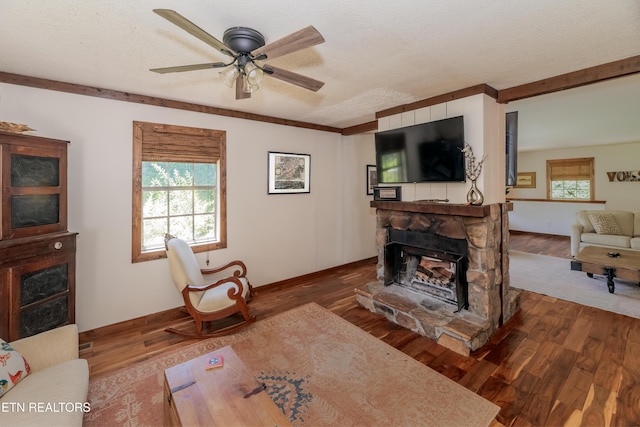 1932 Duncan Rd, Knoxville, TN 37919 - living area with a fireplace, wood finished floors, a ceiling fan, baseboards, and a textured ceiling