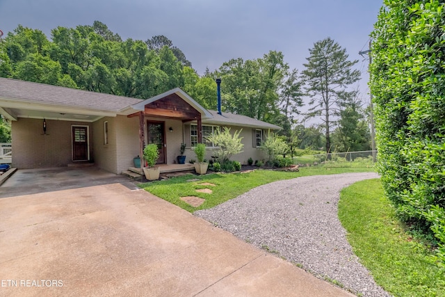 1932 Duncan Rd, Knoxville, TN 37919 - ranch-style house featuring driveway, brick siding, an attached carport, and a shingled roof