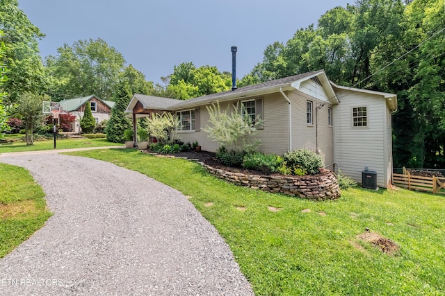 1932 Duncan Rd, Knoxville, TN 37919 - view of front of home featuring brick siding, central AC unit, and driveway