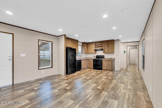 3841 Mcbroom Chapel Rd, Cookeville, TN 38501 - kitchen with black appliances, light wood-type flooring, under cabinet range hood, light countertops, and recessed lighting