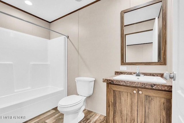 3841 Mcbroom Chapel Rd, Cookeville, TN 38501 - bathroom featuring toilet, vanity, wood finished floors, crown molding, and bathing tub / shower combination