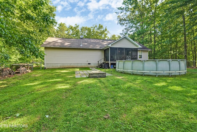 3021 Shawnee Rd, Crossville, TN 38572 - rear view of property with a sunroom, an outdoor pool, a yard, crawl space, and central AC unit