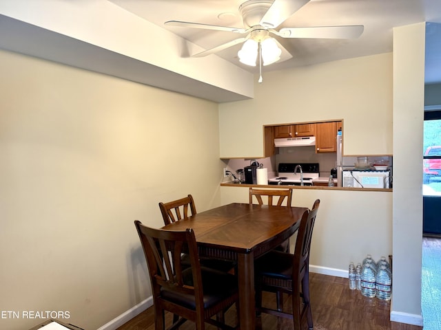 22 Wilshire Heights Dr, Crossville, TN 38558 - dining room with dark wood-style floors, ceiling fan, and baseboards