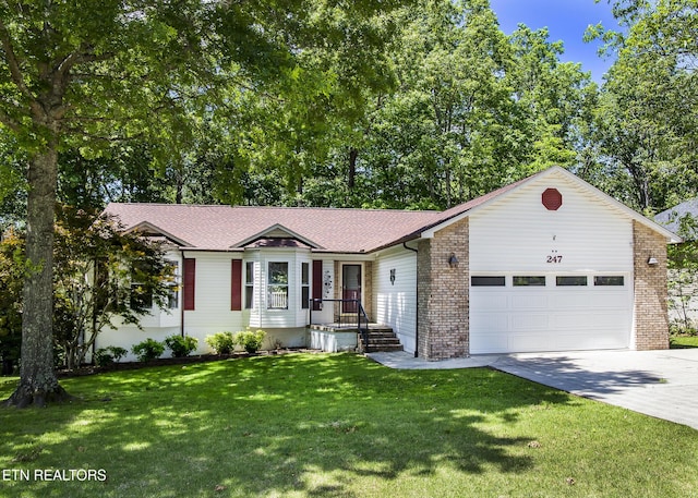 247 Lakeview Dr, Crossville, TN 38558 - ranch-style home featuring concrete driveway, an attached garage, a front yard, and brick siding