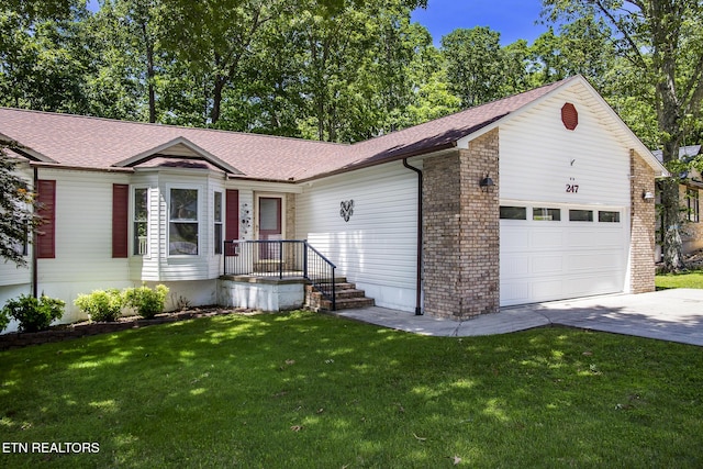 247 Lakeview Dr, Crossville, TN 38558 - view of front of property with a garage, concrete driveway, a front yard, and a shingled roof