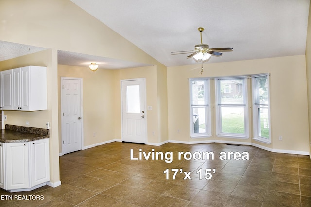 247 Lakeview Dr, Crossville, TN 38558 - kitchen featuring dark countertops, ceiling fan, lofted ceiling, baseboards, and white cabinets