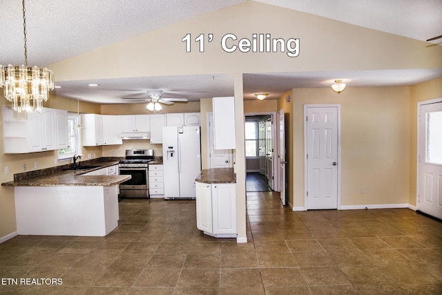 247 Lakeview Dr, Crossville, TN 38558 - kitchen featuring white refrigerator with ice dispenser, stainless steel range with gas stovetop, lofted ceiling, a peninsula, and under cabinet range hood