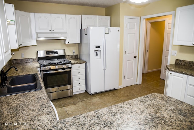 247 Lakeview Dr, Crossville, TN 38558 - kitchen with white fridge with ice dispenser, stainless steel gas stove, a sink, under cabinet range hood, and white cabinetry