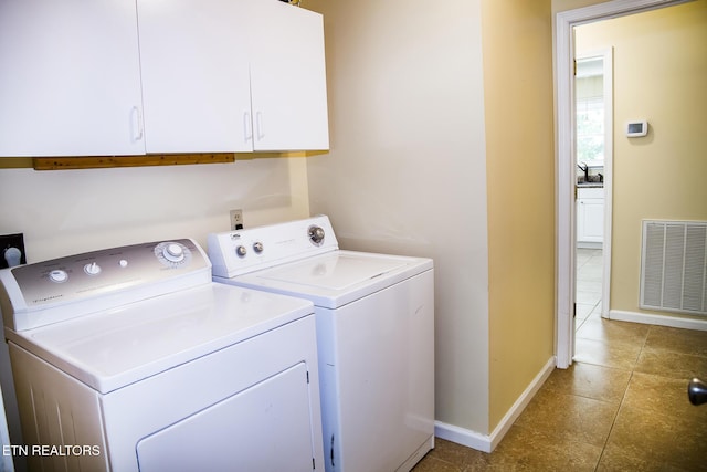 247 Lakeview Dr, Crossville, TN 38558 - laundry area with separate washer and dryer, baseboards, tile patterned flooring, and cabinet space