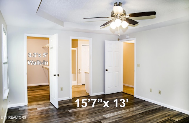 247 Lakeview Dr, Crossville, TN 38558 - unfurnished bedroom featuring wood finished floors, baseboards, ensuite bath, and a ceiling fan