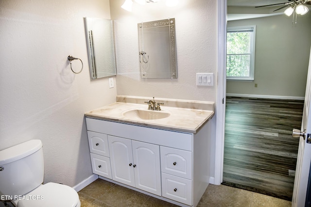 247 Lakeview Dr, Crossville, TN 38558 - bathroom featuring toilet, vanity, ceiling fan, tile patterned flooring, and baseboards