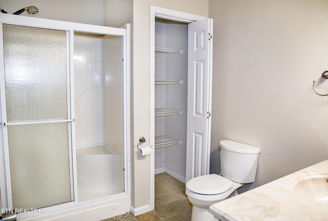 247 Lakeview Dr, Crossville, TN 38558 - full bathroom featuring a shower stall, toilet, vanity, tile patterned flooring, and baseboards