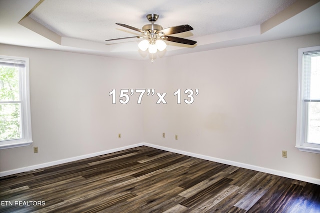 247 Lakeview Dr, Crossville, TN 38558 - empty room featuring dark wood-style flooring, a ceiling fan, a tray ceiling, and baseboards