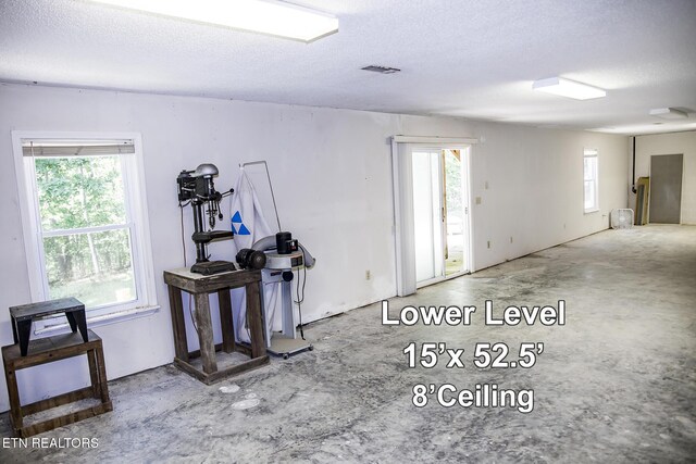 247 Lakeview Dr, Crossville, TN 38558 - spare room featuring unfinished concrete flooring and a textured ceiling