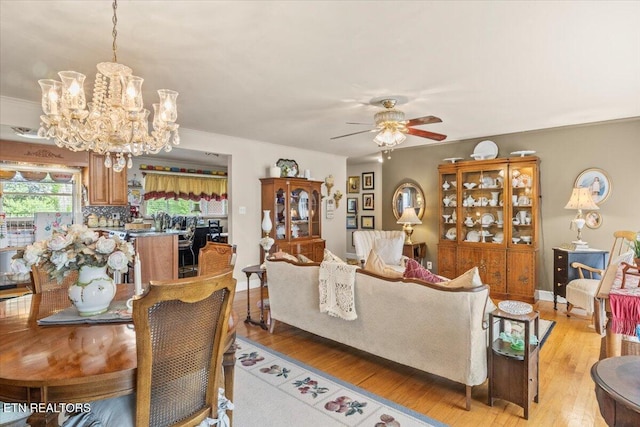 5912 New Beaver Creek Dr, Knoxville, TN 37931 - living area featuring a chandelier, light wood finished floors, a ceiling fan, and crown molding