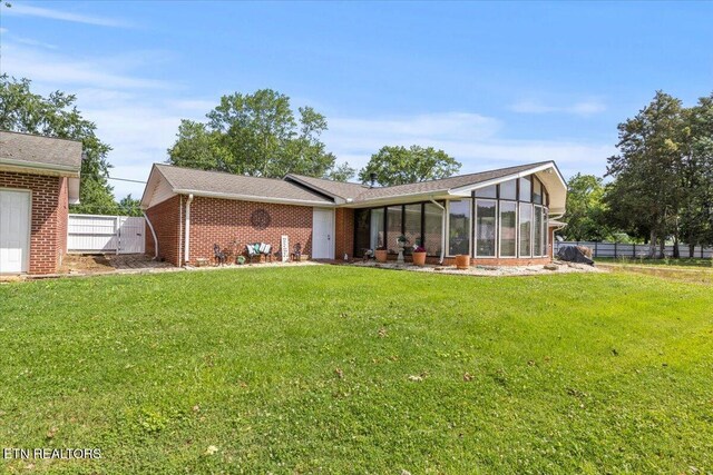 5912 New Beaver Creek Dr, Knoxville, TN 37931 - back of property featuring brick siding and a sunroom