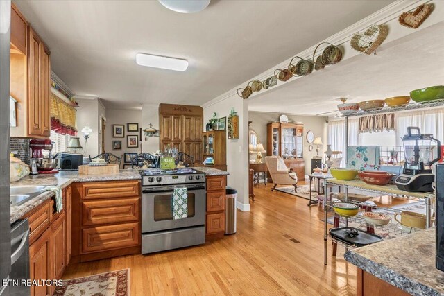 5912 New Beaver Creek Dr, Knoxville, TN 37931 - kitchen with appliances with stainless steel finishes, brown cabinetry, light wood-style floors, and crown molding