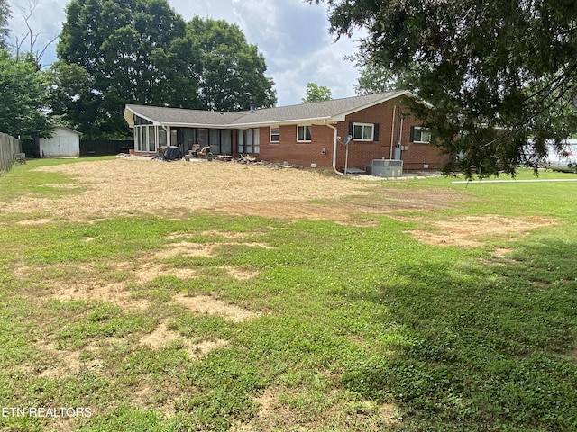 5912 New Beaver Creek Dr, Knoxville, TN 37931 - rear view of property with brick siding, a sunroom, central AC unit, and a yard