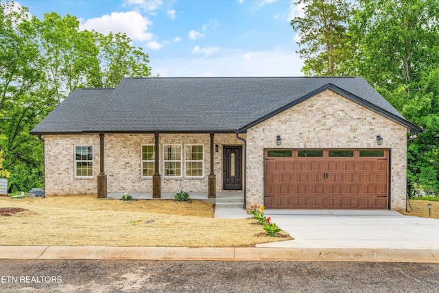 1287 Lori Ellen Ct, Sevierville, TN 37876 - view of front of house with roof with shingles, a garage, driveway, and a porch