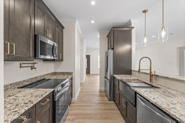1287 Lori Ellen Ct, Sevierville, TN 37876 - kitchen with appliances with stainless steel finishes, ornamental molding, dark brown cabinetry, light stone counters, and recessed lighting