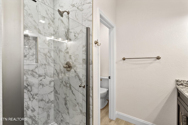 1287 Lori Ellen Ct, Sevierville, TN 37876 - bathroom with vanity, a marble finish shower, toilet, wood finished floors, and baseboards