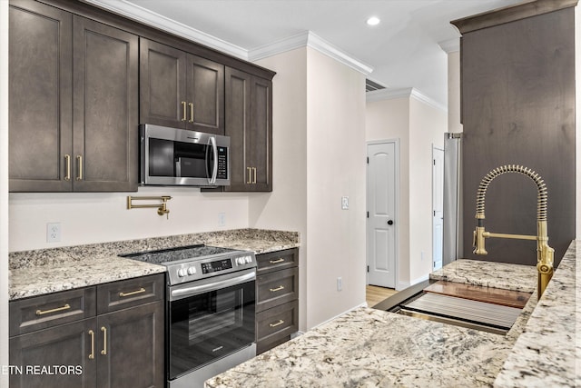 1287 Lori Ellen Ct, Sevierville, TN 37876 - kitchen featuring stainless steel appliances, ornamental molding, dark brown cabinetry, light stone counters, and a sink