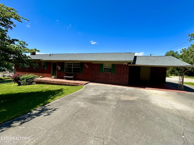762 Commanche Dr, Jefferson City, TN 37760 - ranch-style house with concrete driveway, a front lawn, brick siding, an attached carport, and a porch