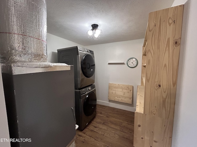 724 Montvue Ave, Morristown, TN 37813 - washroom with stacked washer / dryer, dark wood-style floors, baseboards, and a textured ceiling