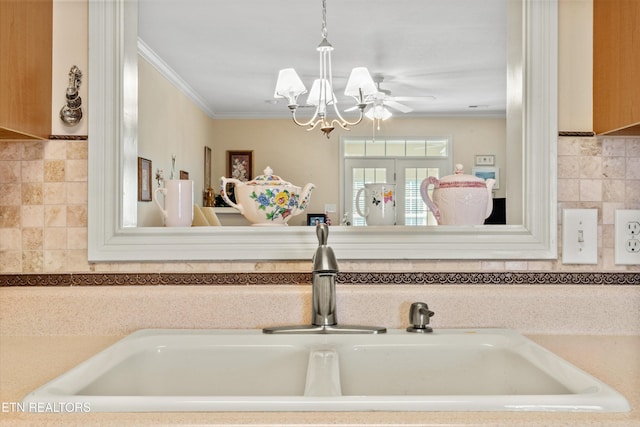 7830 Thomas Henry Way, Knoxville, TN 37938 - kitchen view of a sink, ornamental molding, a chandelier, pendant lighting, and decorative backsplash