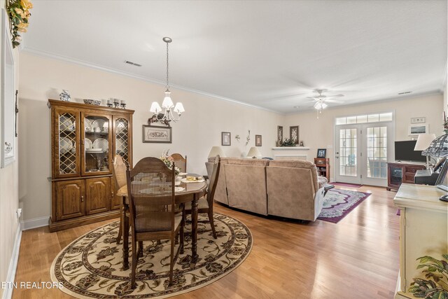 7830 Thomas Henry Way, Knoxville, TN 37938 - dining room with a chandelier, light wood-style floors, ceiling fan, crown molding, and baseboards