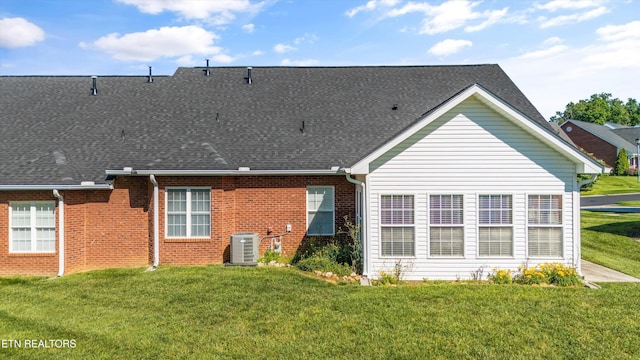 7830 Thomas Henry Way, Knoxville, TN 37938 - back of property featuring a lawn, brick siding, cooling unit, and a shingled roof