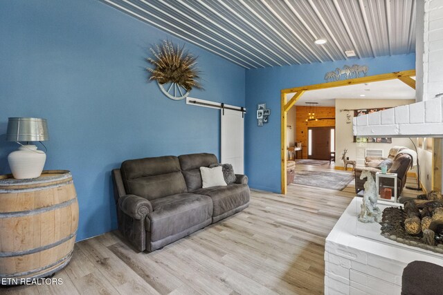 2115 Riverview Dr, Dandridge, TN 37725 - living area with a barn door and wood finished floors