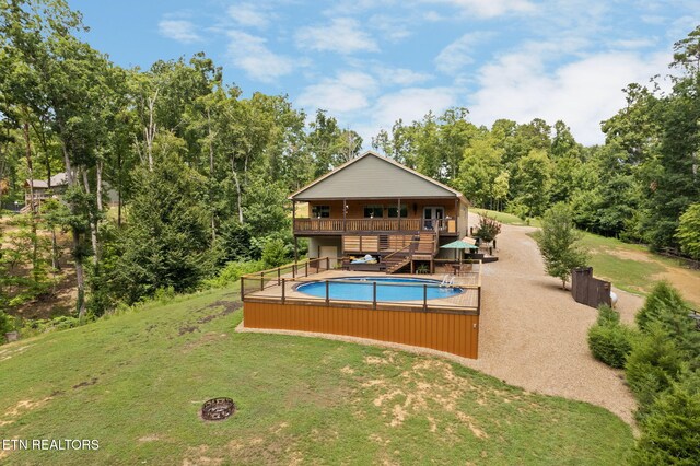 2115 Riverview Dr, Dandridge, TN 37725 - outdoor pool featuring a yard, stairs, a deck, and a wooded view