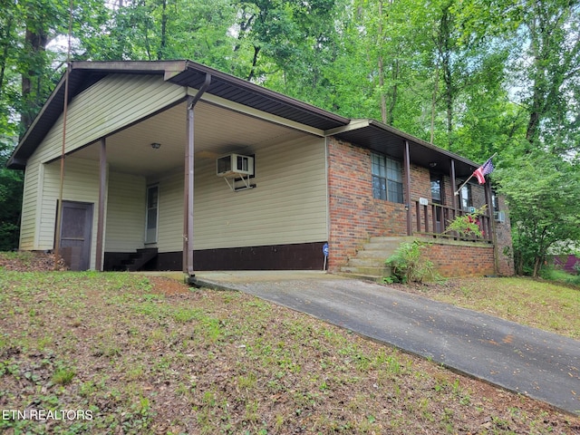 1403 Skyline Dr, New Market, TN 37820 - view of side of property with an attached carport, driveway, a porch, brick siding, and entry steps
