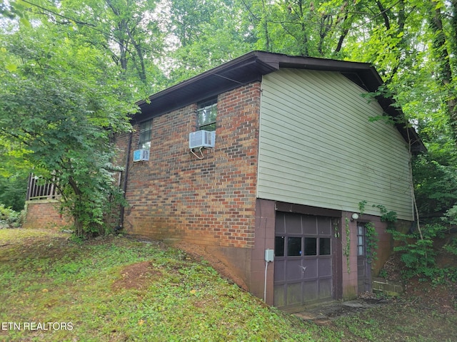 1403 Skyline Dr, New Market, TN 37820 - view of side of property with an attached garage, brick siding, and cooling unit