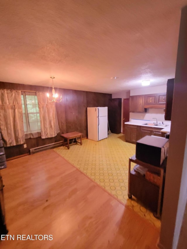 1403 Skyline Dr, New Market, TN 37820 - living area with light wood-type flooring, a chandelier, wooden walls, and a baseboard radiator
