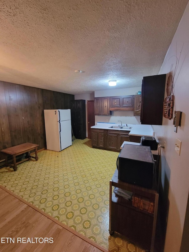 1403 Skyline Dr, New Market, TN 37820 - kitchen with freestanding refrigerator, light countertops, a sink, black microwave, and a textured ceiling