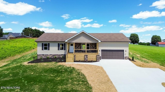 294 Mountain Perkins Ln, Jacksboro, TN 37757 - view of front of home featuring a garage, a front yard, stone siding, and driveway