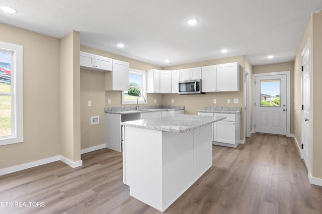 294 Mountain Perkins Ln, Jacksboro, TN 37757 - kitchen featuring stainless steel microwave, white cabinets, light wood-style flooring, a sink, and recessed lighting