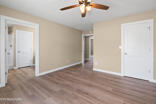 294 Mountain Perkins Ln, Jacksboro, TN 37757 - unfurnished bedroom with wood finished floors, baseboards, and ceiling fan