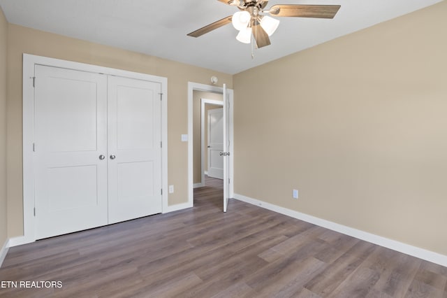 294 Mountain Perkins Ln, Jacksboro, TN 37757 - unfurnished bedroom with baseboards, wood finished floors, a closet, and ceiling fan
