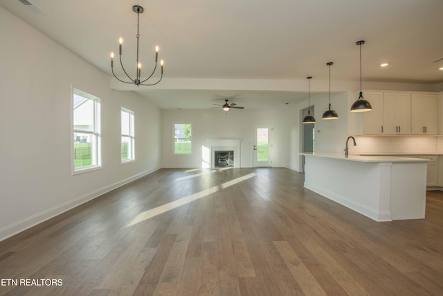 349 Ivey Farms Ln, Farragut, TN 37934 - unfurnished living room featuring a chandelier, wood finished floors, a fireplace, recessed lighting, and a ceiling fan