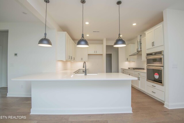 349 Ivey Farms Ln, Farragut, TN 37934 - kitchen featuring appliances with stainless steel finishes, backsplash, a peninsula, light wood-type flooring, and recessed lighting