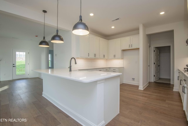 349 Ivey Farms Ln, Farragut, TN 37934 - kitchen with a peninsula, decorative backsplash, white cabinetry, dark wood-style flooring, and recessed lighting