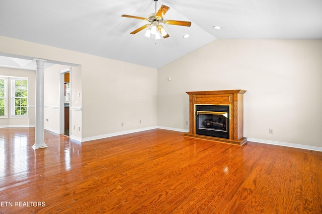 178 Scenic Hill Ln, Lenoir City, TN 37771 - unfurnished living room with lofted ceiling, ornate columns, wood finished floors, ceiling fan, and a glass covered fireplace