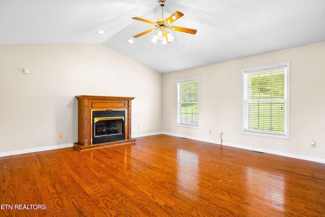 178 Scenic Hill Ln, Lenoir City, TN 37771 - unfurnished living room featuring wood finished floors, plenty of natural light, a fireplace with raised hearth, ceiling fan, and lofted ceiling