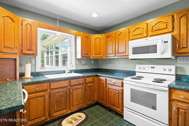 178 Scenic Hill Ln, Lenoir City, TN 37771 - kitchen featuring white appliances, a sink, dark countertops, brown cabinetry, and recessed lighting