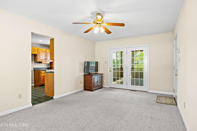 178 Scenic Hill Ln, Lenoir City, TN 37771 - unfurnished living room featuring a ceiling fan, dark carpet, and baseboards