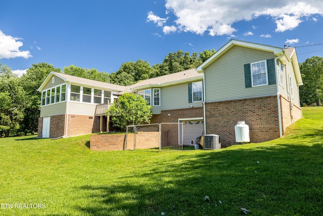 178 Scenic Hill Ln, Lenoir City, TN 37771 - rear view of property featuring a sunroom, brick siding, a garage, and central AC unit